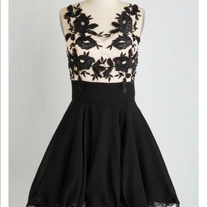 Black and nude dress with flowered appliqués